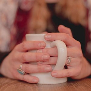 close up of hands holding a mug