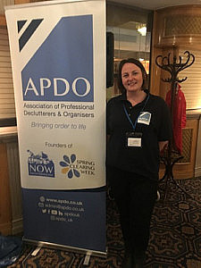 APDO member Lisa Panting standing with APDO Banner