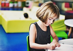 Little girl doing her homework at a table